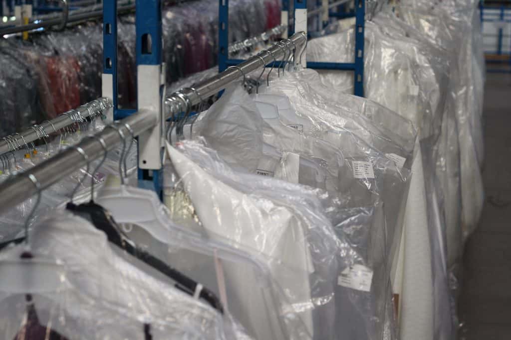 Garments stored on a rail in a warehouse - fashion logistics